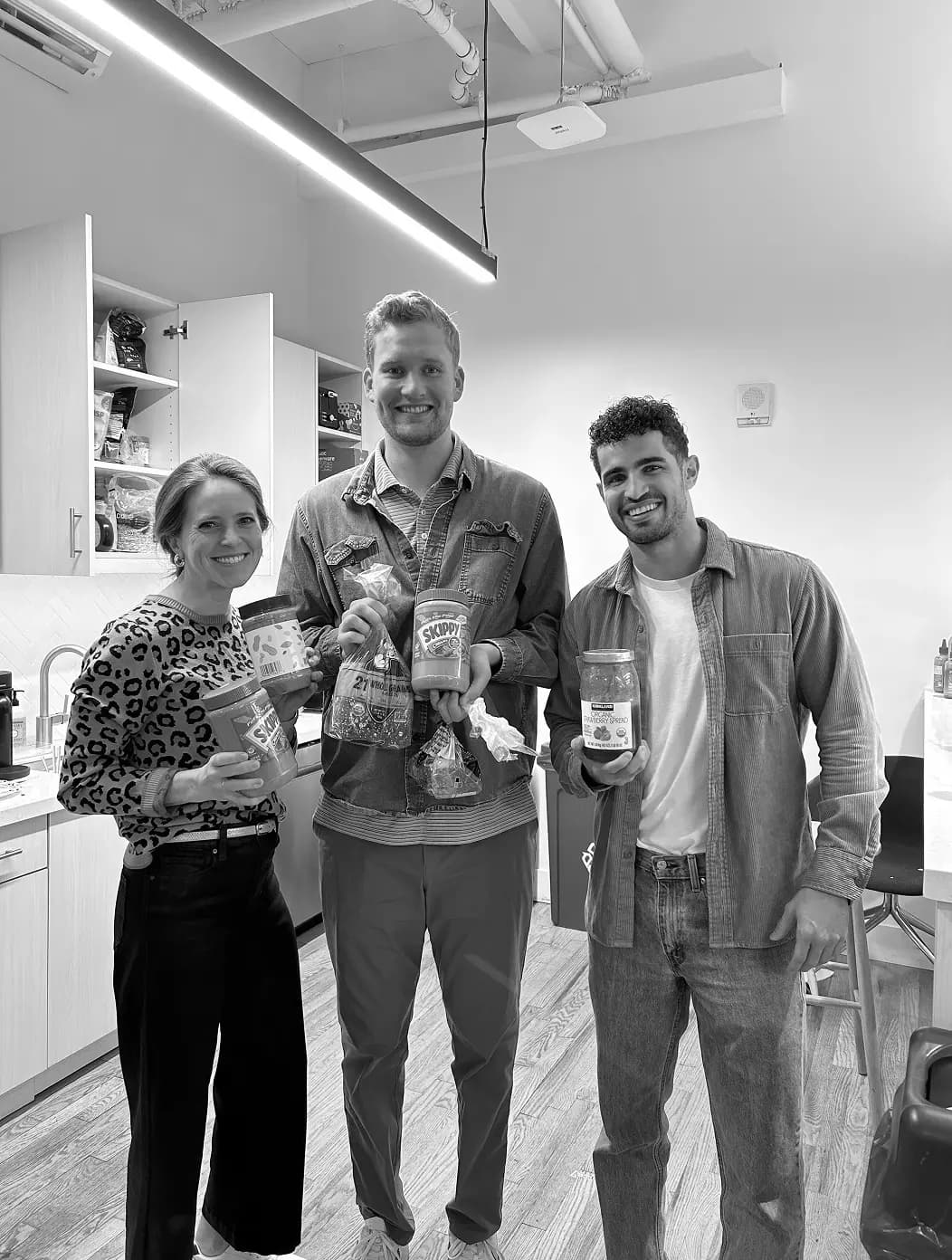Teammates sharing snacks in the office kitchen