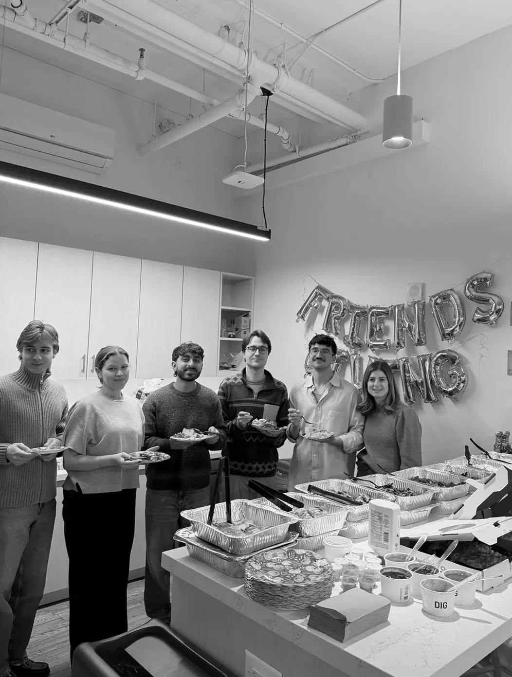 Teammates sharing a Friendsgiving meal in the office